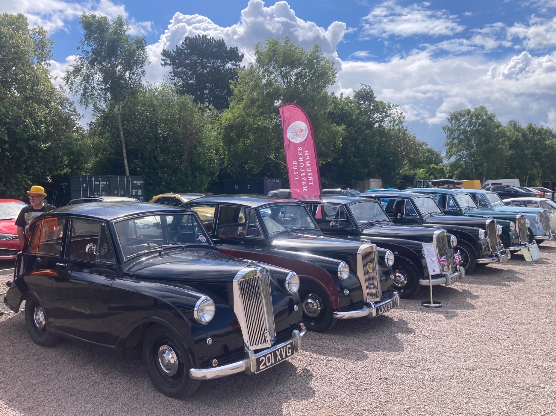 Triumph Mayflower classic cars parked in a row, seen from the front and slightly to the side.