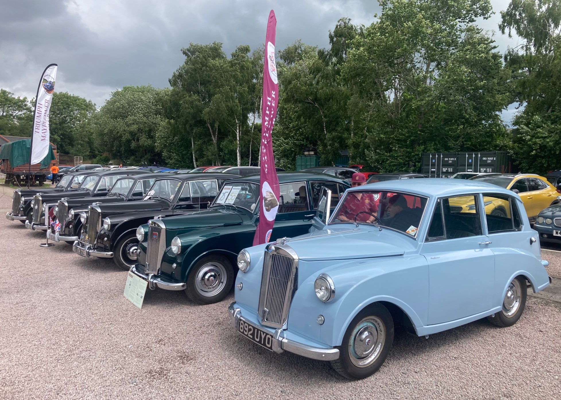 Triumph Mayflower classic cars parked in a row, seen from the front and slightly to the side.